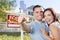 Excited Military Couple In Front of Home, House Keys and Sign