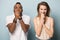 Excited multiracial man and woman hope for luck