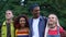 Excited multiracial students couples walking in park and smiling, friendship