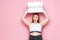 Excited overweight girl holding placard with