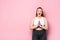 Excited overweight girl standing with praying