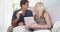 Excited parents smiling at camera with credit card