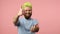 Excited positive man with dyed bright green hair showing thumbs up and smiling