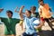 Excited preteen boys cheering after game on beach