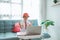 excited primary school student with uniform raise her arm during online class