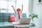 excited primary school student with uniform raise her arm during online class