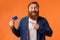 Excited Redhaired Bearded Guy Showing Credit Card Over Orange Background