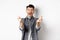 Excited romantic man showing hand hearts and smiling at camera, express love and affection, standing on white background