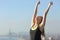 Excited runner woman raising arms celebrating success