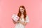 Excited sassy good-looking redhead woman in stylish white dress, holding wrapped present, asking guess whats inside