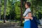 Excited schoolgirl hugs mom behind her back. The girl missed her mother very much.