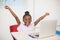 Excited schoolgirl with laptop in classroom