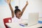 Excited schoolgirl with laptop in classroom