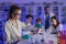 Excited science students with teacher doing chemical experiment in the laboratory at university.