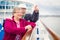 Excited Senior Adult Couple Enjoying The View From Their Passenger Cruise Ship Railing