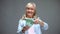 Excited senior female counting euro banknotes, planning purchases, loan service