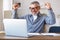 Excited senior man celebrating success, getting good exam results during distant education