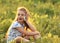 Excited serious cute kid girl sitting on the glass and talking o