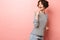 Excited shocked surprised beautiful woman posing isolated over pink wall background pointing