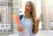 Excited student girl raising fist up celebrating outdoors