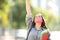 Excited student wearing mask raising arm in the street