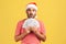 Excited surprised man with beard in santa claus hat holding dollars in hand, ready to buy christmas gifts, loan