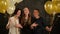 Excited Surprised Women Hiding among Balloons Having Fun during a Party. Closeup Portrait of Three Smiling Girls in the