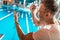 excited swim trainer with stopwatch standing at competition