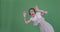 Excited tattooed woman greeting hello with both hands over green screen