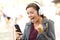 Excited teen listening music on a phone