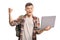 Excited teenage boy holding a laptop and gesturing with hand
