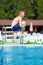 Excited teenage boy jumping in pool