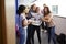 Excited Teenage High School Students Celebrating Exam Results In School Corridor