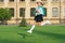 Excited teenager in school uniform jumping midair. Energetic teenage girl back to school. September 1