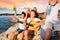 Excited teens having picnic at the seaside