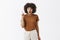 Excited and thrilled creative artistic dark-skinned girl with afro hairstyle adding suggesting raising index finger in