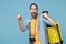 Excited traveler tourist man in summer clothes with photo camera isolated on blue background. Male passenger traveling