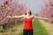 Excited woman celebrating spring outstretching arms