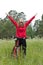 Excited woman cyclist with hands outstretched