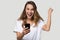 Excited woman holding smartphone feels overjoyed celebrating victory