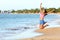 Excited Woman Jumping At Beach - Fitness girl
