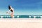 Excited woman leaping at beach