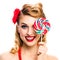 Excited woman with lollipop. Pin up girl with happy smile. Isolated
