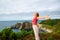 Excited woman outstretching arms screaming on the beach