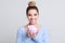 Excited woman with piggy bank on background