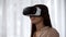 Excited woman playing a video game in virtual reality, spinning head in VR