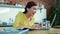 Excited woman reading good news on laptop. Girl drinking water in kitchen.