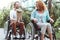 Excited woman receiving bouquet while driving her wheelchair