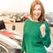 Excited woman receiving key in front of cars