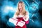 Excited woman in santa costume opening christmas gift